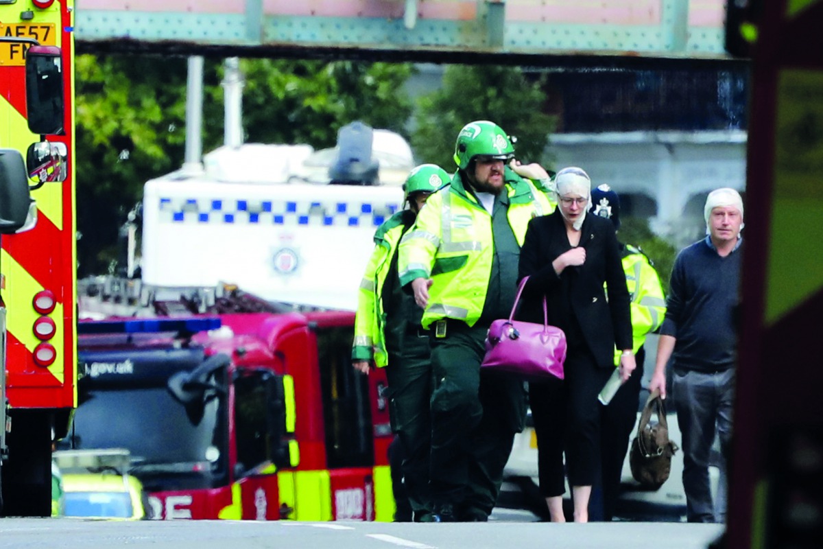 An injured woman is led away after an incident at Parsons Green underground station in London, Britain, September 15, 2017. Reuters/Luke MacGregor