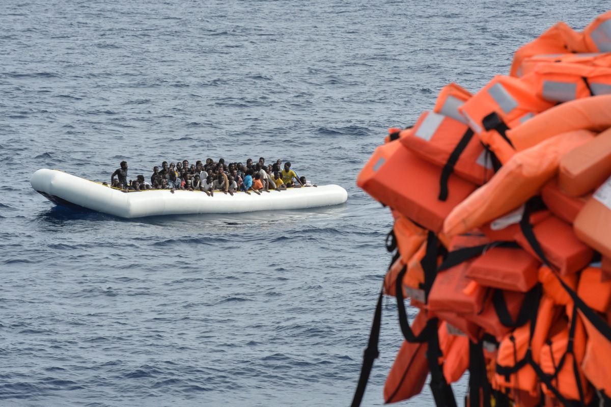 FILE PHOTO: Migrants on a rubber boat waiting to be evacuated during a rescue operation by the crew of the Topaz Responder on November 5, 2016 off the coast of Libya. (AFP / Andreas Solaro) 