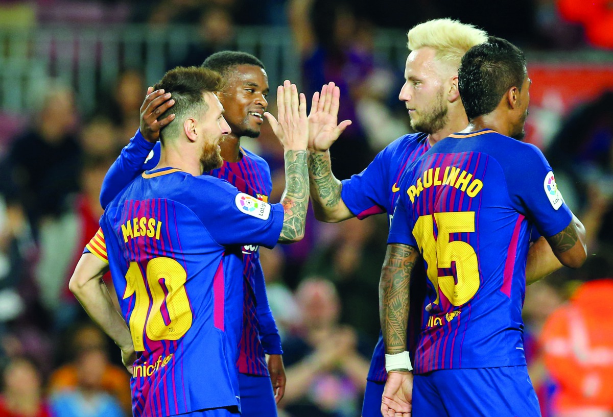 Barcelona’s forward Lionel Messi (left) celebrates with team-mates after scoring during the Spanish league match against SD Eibar at the Camp Nou Stadium in Barcelona on Tuesday.