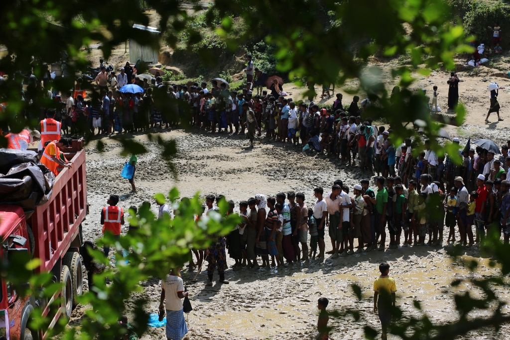 Rohingya Muslims, fled from ongoing military operations in Myanmar’s Rakhine state, stand in line to receive humanitarian aids at a makeshift camp in Teknaff, Bangladesh on September 22, 2017.  Zakir Hossain Chowdhury - AA
