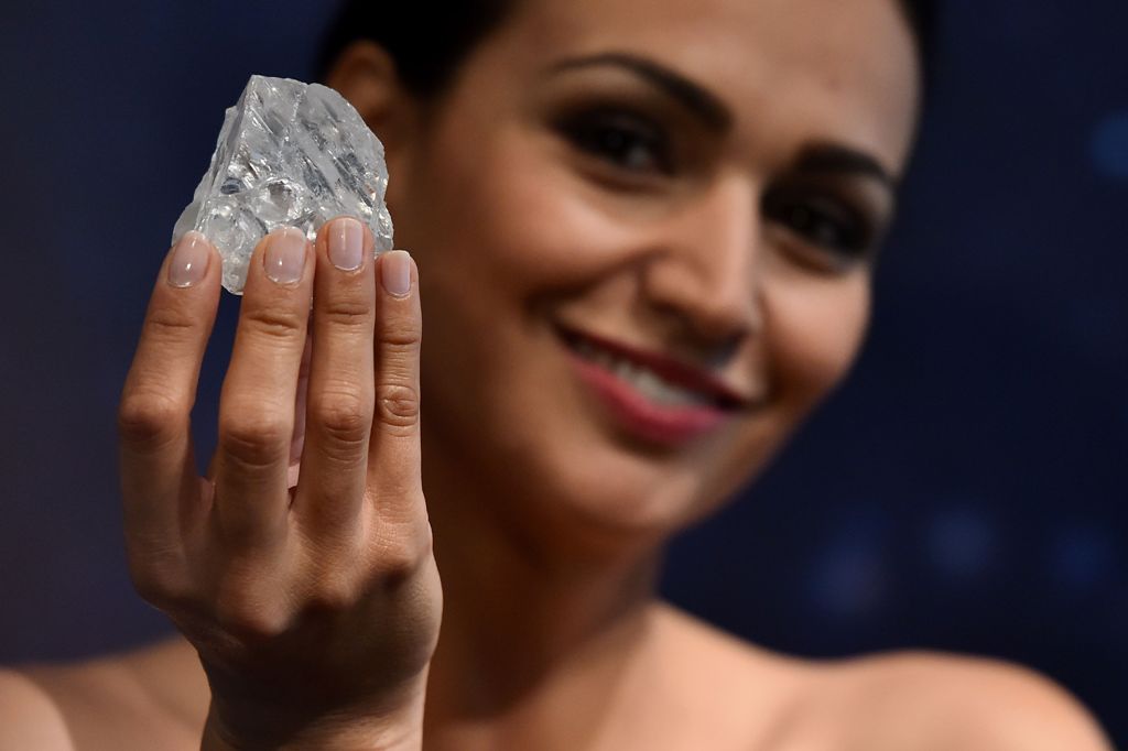 (FILES) This file photo taken on June 14, 2016 shows a model posing with an uncut 1109-carat diamond named 'Lesedi La Rona' at Sotheby's auction house in London. Graff diamonds have purchased the Lesedi La Rona diamond on September 26, 2017 for $53 millio
