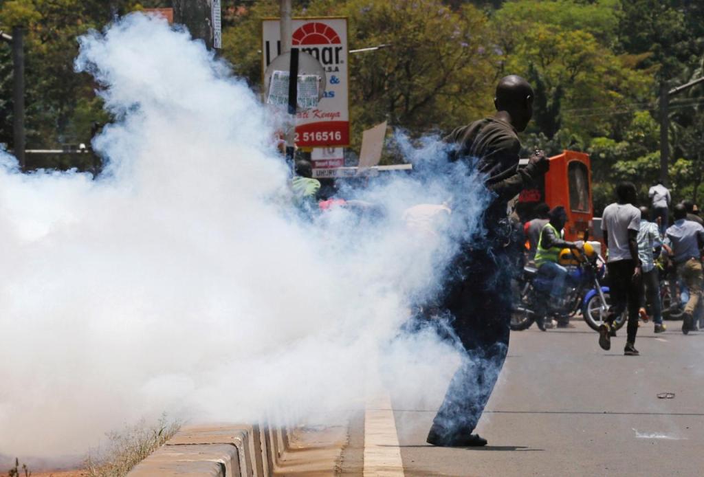 A supporter of the opposition National Super Alliance (NASA) coalition runs after riot policemen dispersed protesters during a demonstration calling for the removal of Independent Electoral and Boundaries Commission (IEBC) officials in Nairobi, Kenya Sept