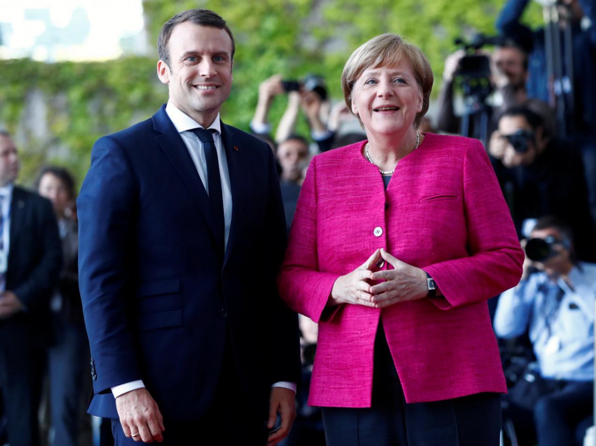 German Chancellor Angela Merkel and French President Emmanuel Macron arrive at a ceremony at the Chancellery in Berlin, Germany, May 15, 2017. Reuters/Fabrizio Bensch 