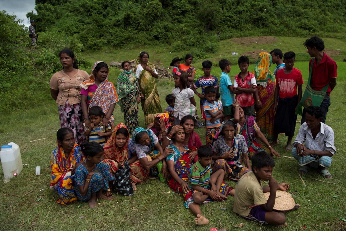 Hindu people cry near the dead bodies of their family members in Yebawkya village, Maungdaw on September 27, 2017. Myanmar's army said on September 24, 2017 it had discovered a mass grave containing the bodies of 28 Hindus, including women and children, i