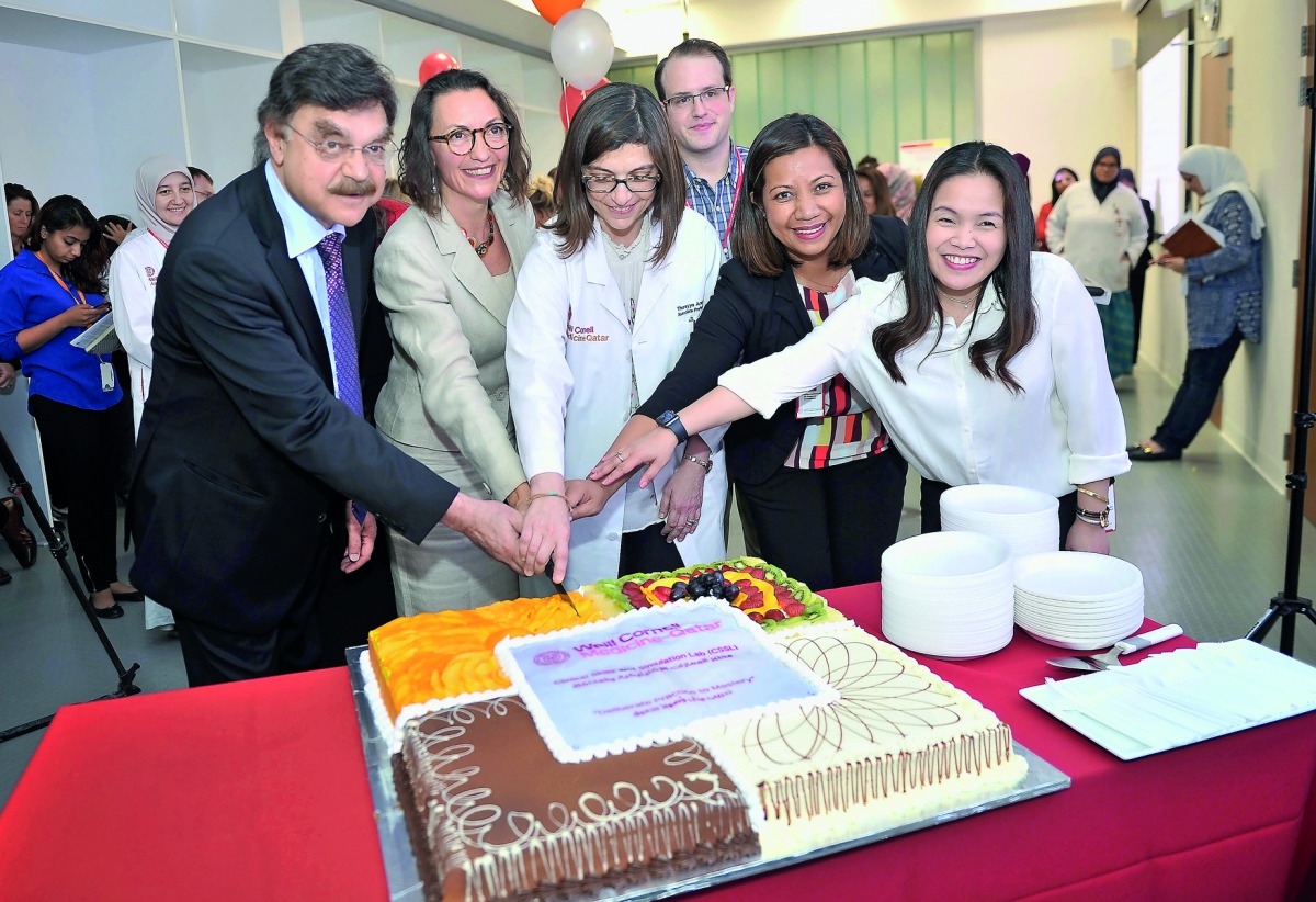 Dr. Javaid I Sheikh, Dean of Weill Cornell Medical College in Qatar; Dr. Stella Major, Director of  Clinical Skills and Simulation Lab; and Lan Sawan, Manager of Clinical Skills and Simulation Lab with other officials cutting a cake to mark the official i