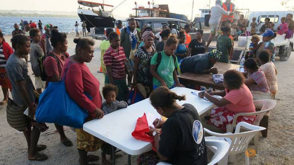 Residents evacuated due to the the Manaro Voui volcano, located on Vanuatu's northern island Ambae, register with authorities after disembarking from a boat at Luganville port, on Vanuatu's Espiritu Santos Island located in the South Pacific, October 3, 2