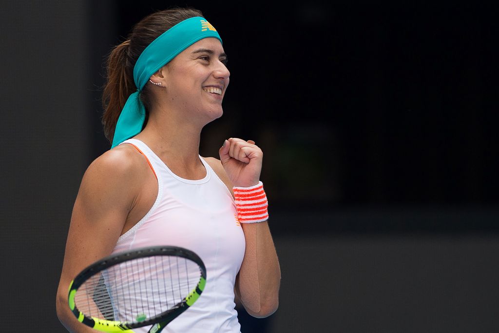 Sorana Cirstea of Romania celebrates winning her women's singles match against Karolina Pliskova of the Czech Republic at the China Open tennis tournament in Beijing on October 5, 2017. / AFP / Nicolas ASFOURI