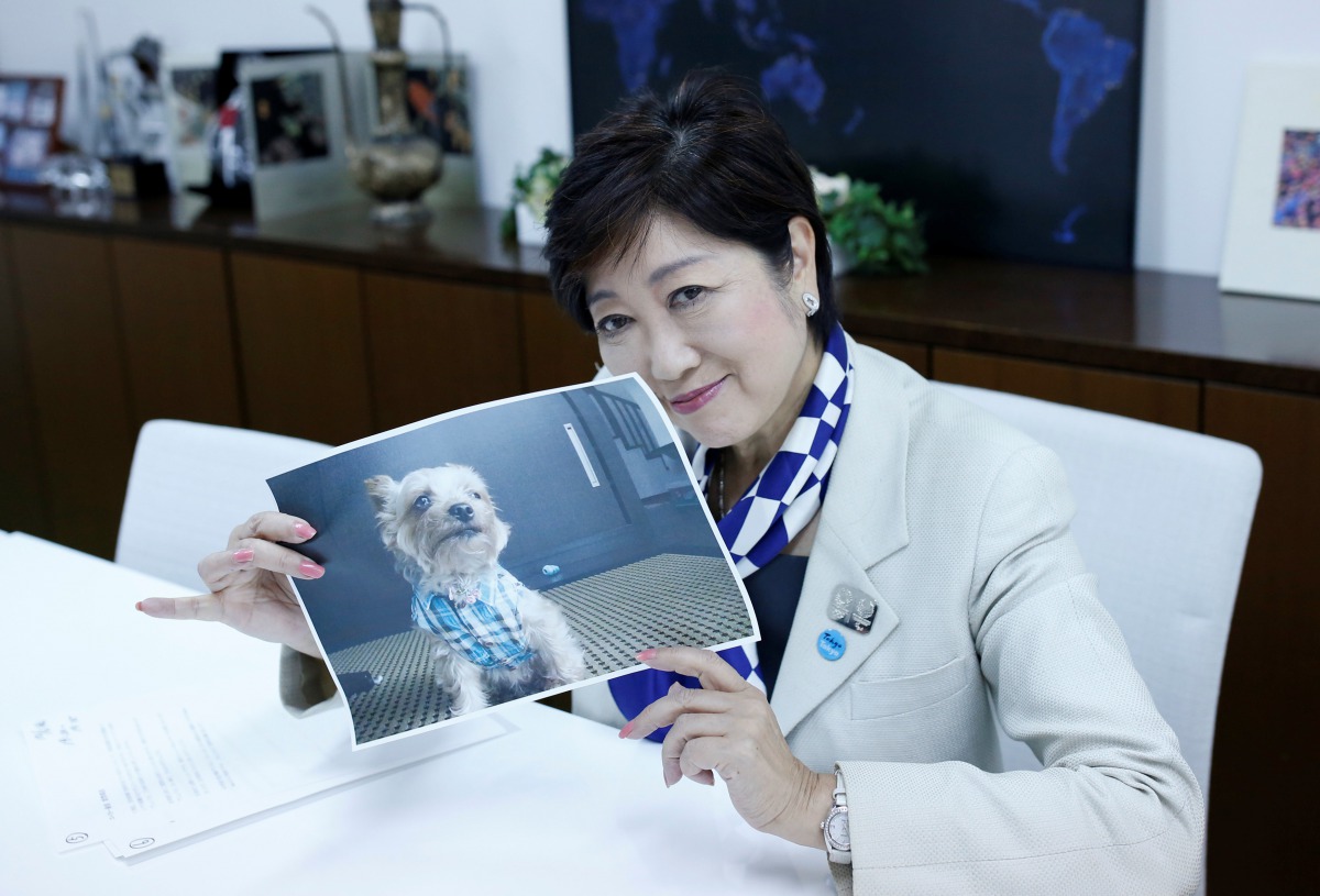 Tokyo Governor Yuriko Koike, head of Japan's Party of Hope, shows a picture of her pet dog named So-chan during an interview with Reuters in Tokyo, Japan October 6, 2017. Reuters/Issei Kato