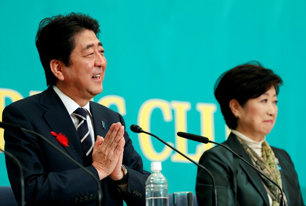 Japan's Prime Minister Shinzo Abe (L), who is also ruling Liberal Democratic Party leader, and Head of Japan's Party of Hope and Tokyo Governor Yuriko Koike attend a debate session ahead of October 22 lower house election at the Japan National Press Club 