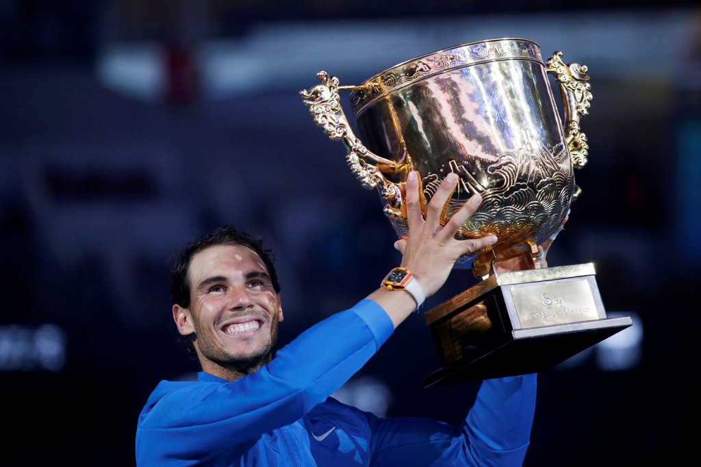 Rafael Nadal of Spain holds the trophy after winning the match against Nick Kyrgios of Australia. REUTERS/Jason Lee
