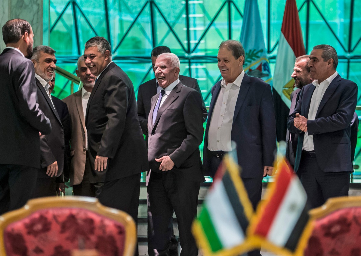 Khaled Fawzi (C) head of the Egyptian Intelligence services laugh with Hamas leader Izzat al-Rishq (2nd-R) and Hamas' leader in the Gaza Strip Yahya Sinwar (background) in the presence of Fatah's Azzam al-Ahmad (C) and Rawhi Fattouh (3rd-R) following the 
