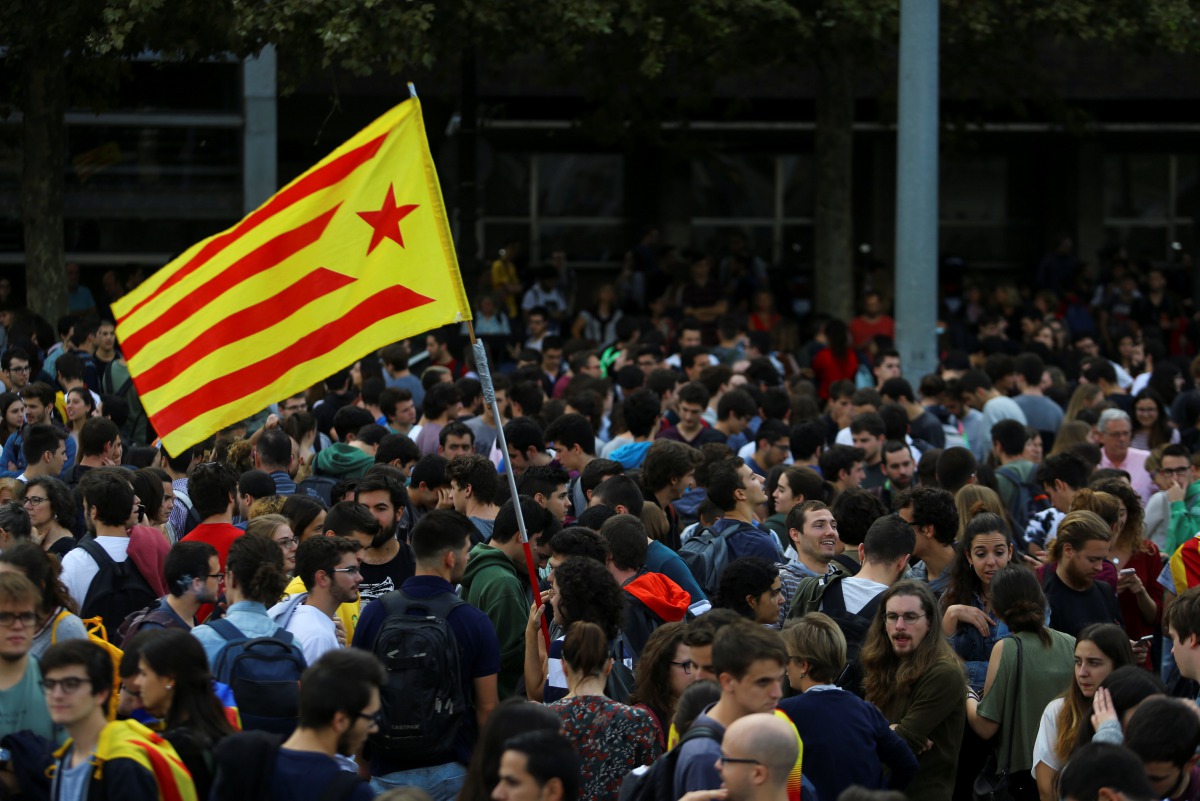 Students wave an Estelada (Catalan separatist flag) during a gathering to protest against the imprisonment of leaders of two of the largest Catalan separatist organizations, Catalan National Assembly's Jordi Sanchez and Omnium's Jordi Cuixart, who were ja
