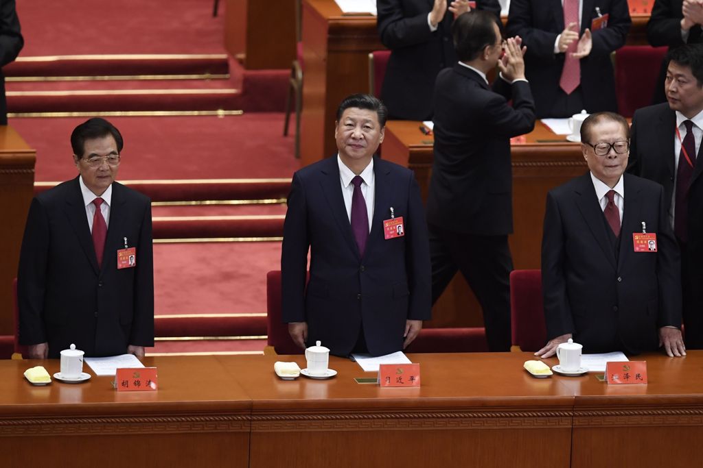 Chinese President Xi Jinping (C) and Chinese former president Hu Jintao (L), Chinese former president Jiang Zemin (2nd R) attend the opening session of the Chinese Communist Party's Congress at the Great Hall of the People in Beijing on October 18, 2017. 