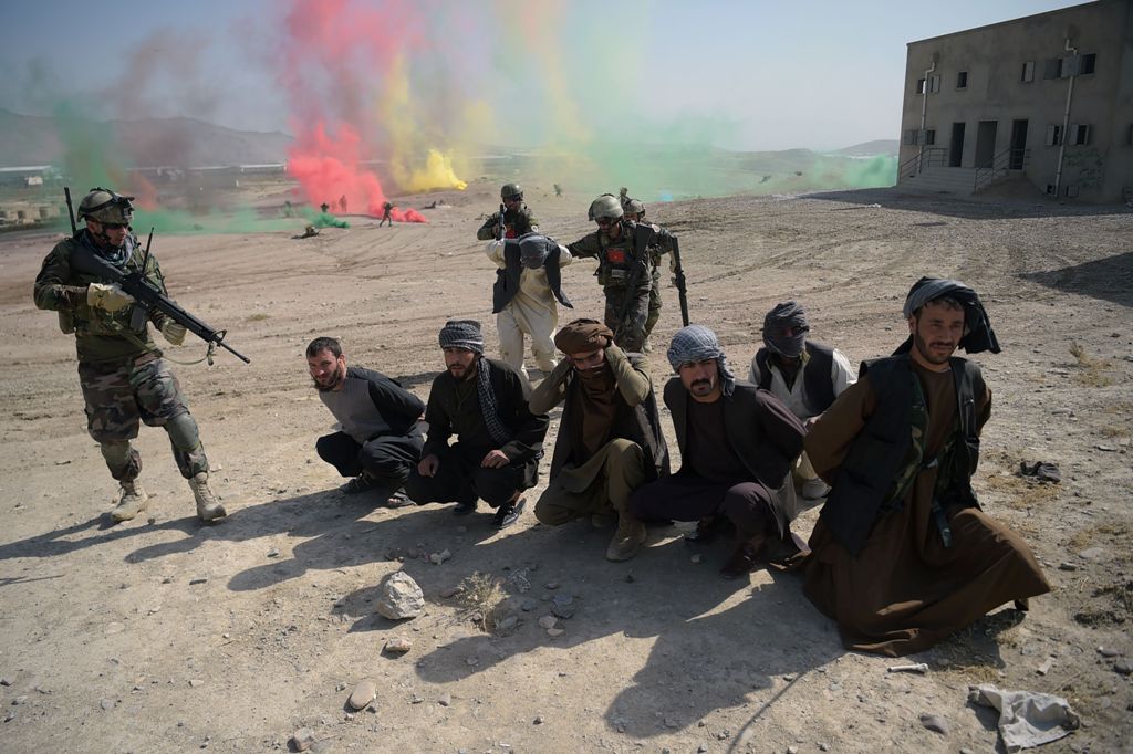 Afghan National Army (ANA) commandos arrest men pretending to be Taliban fighters during a military exercise at the Kabul Military Training Centre (KMTC) on the outskirts of Kabul on October 17, 2017. AFP / SHAH MARAI
