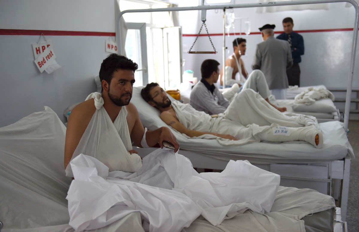 FILE PHOTO: A wounded Afghan police man looks on as he receives treatment following the militants raid that targeted the American University of Afghanistan on August 25. 2016 (AFP) 