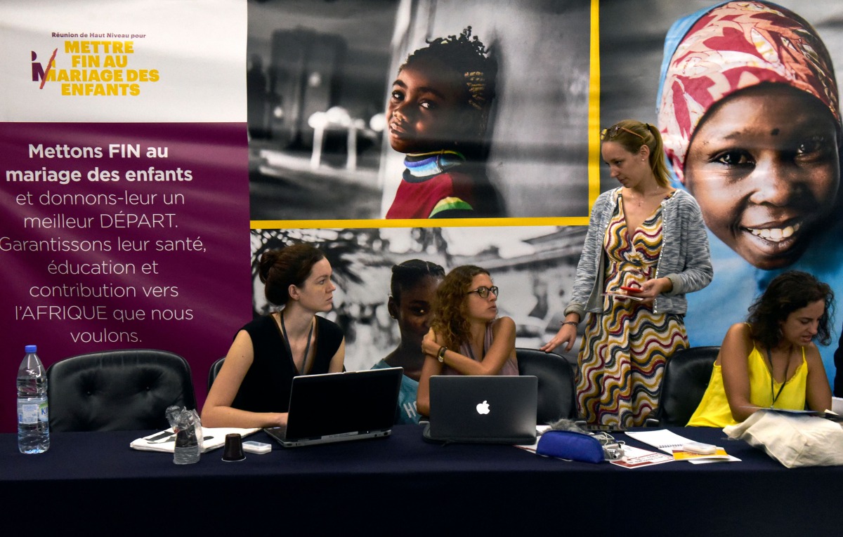 Experts sit by their laptop as they attend a high-level meeting to end forced children marriage, in Dakar, on October 23, 2017.  AFP / Seyllou