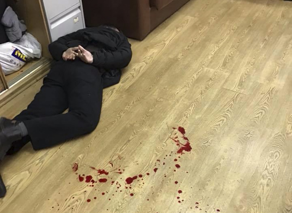 An intruder, who attacked anchor of Russian radio station Ekho Moskvy Tatyana Felgengauer, lies on the floor after he was detained at the station's office in Moscow, Russia October 23, 2017. Reuters/Vitaly Ruvinskiy

