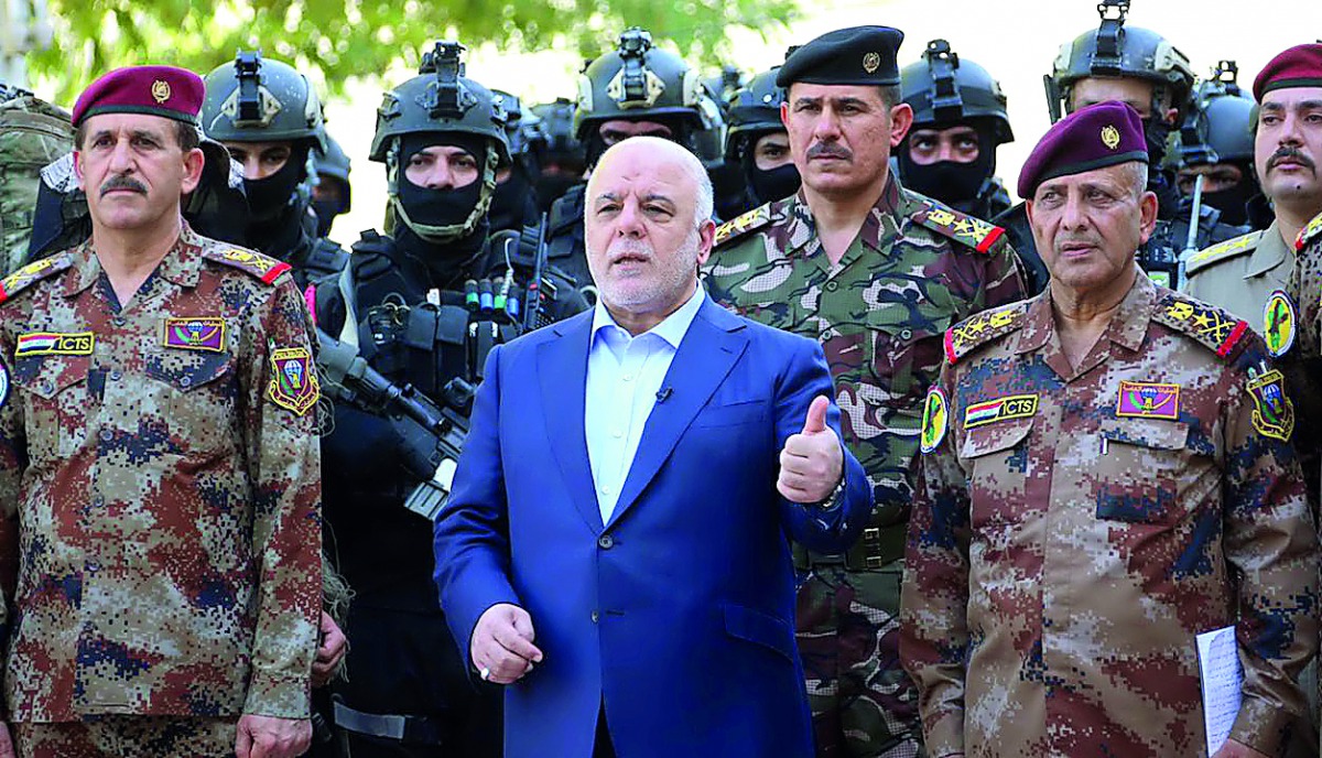 Iraqi Prime Minister Haider Al Abadi with army generals and members of the counter-terrorism forces in the capital Baghdad in this July 2016 file picture. 
