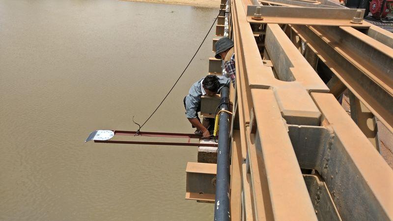 Automated water gauge that helps predict flood is fixed to a bridge over a river in Cambodia. 