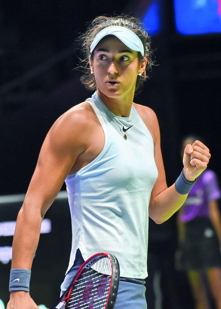 Caroline Garcia of France reacts on a point against Elina Svitolina of Ukraine during the WTA Finals tennis tournament in Singapore on October 25, 2017.  AFP / Roslan Rahman