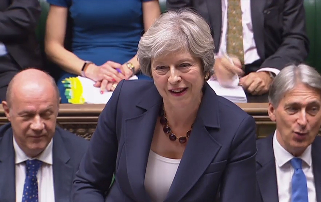 A still image taken from footage broadcast by the UK Parliament's Parliamentary Recording Unit (PRU) shows Britain's Prime Minister Theresa May as she speaks during the weekly Prime Minister's Questions (PMQs) session in the House of Commons in London on 