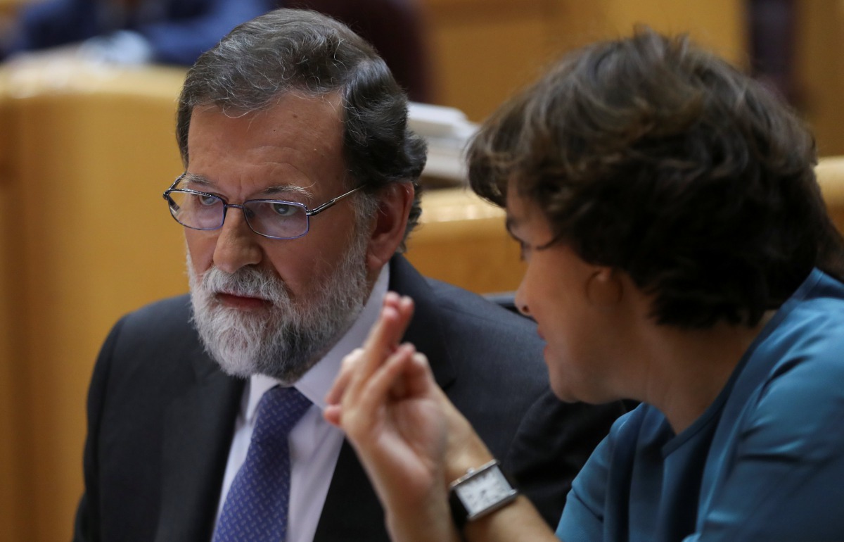 Spain's Prime Minister Mariano Rajoy (L) listens to Deputy Prime Minister Soraya Saenz de Santamaria during a debate at the upper house Senate in Madrid, Spain, October 27, 2017. REUTERS/Susana Vera
