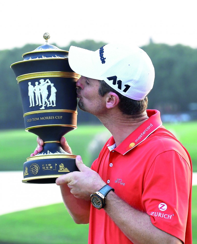 Justin Rose of England kisses his trophy after he stormed back from eight shots behind overnight to win the $9.75m WGC-HSBC Champions by two strokes in a thrilling finale at the Sheshan International golf club in Shanghai yesterday.