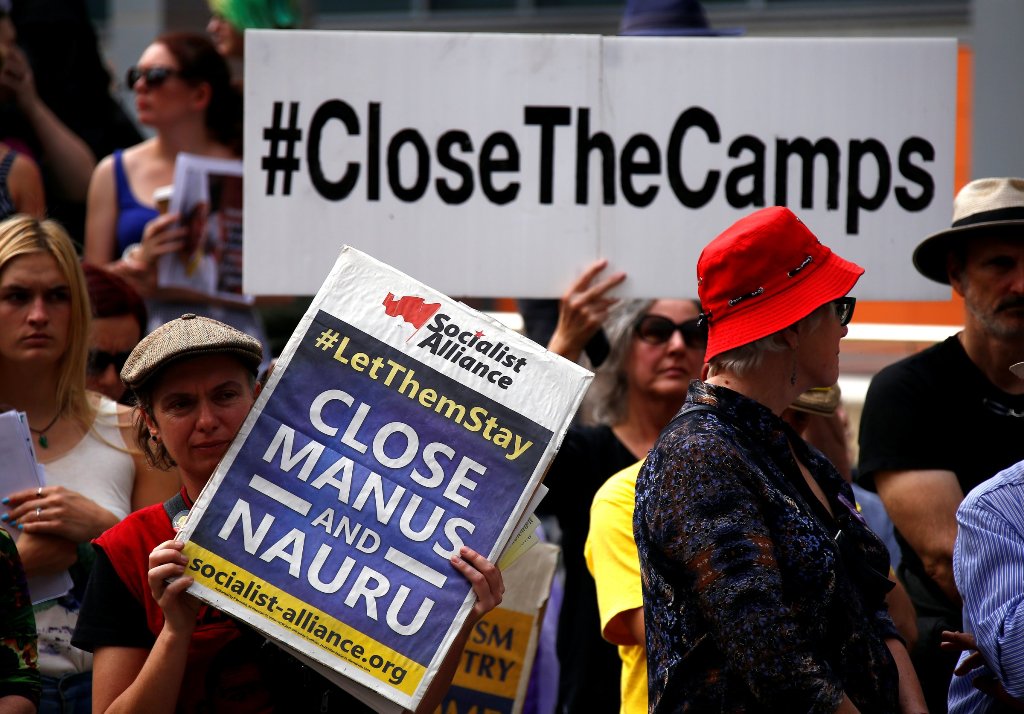 A file photo of the protesters from the Refugee Action Coalition hold placards during a demonstration outside the offices of the Australian Government Department of Immigration and Border Protection in Sydney, Australia, April 29, 2016. Reuters/David Gray
