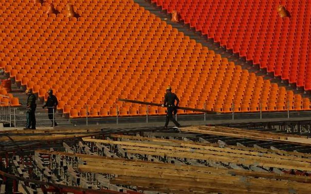 In a photo taken on Oct 27, 2017 workers carry materials at the stadium of the Pyeongchang Winter Olympics 2018 opening ceremony, in Pyeongchang. (Photo: AFP/ Sebastien Berger).