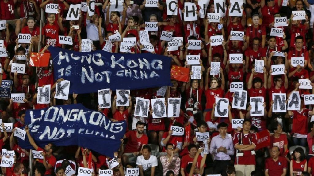 FILE: Hong Kong fans hold banners and character signs which read 