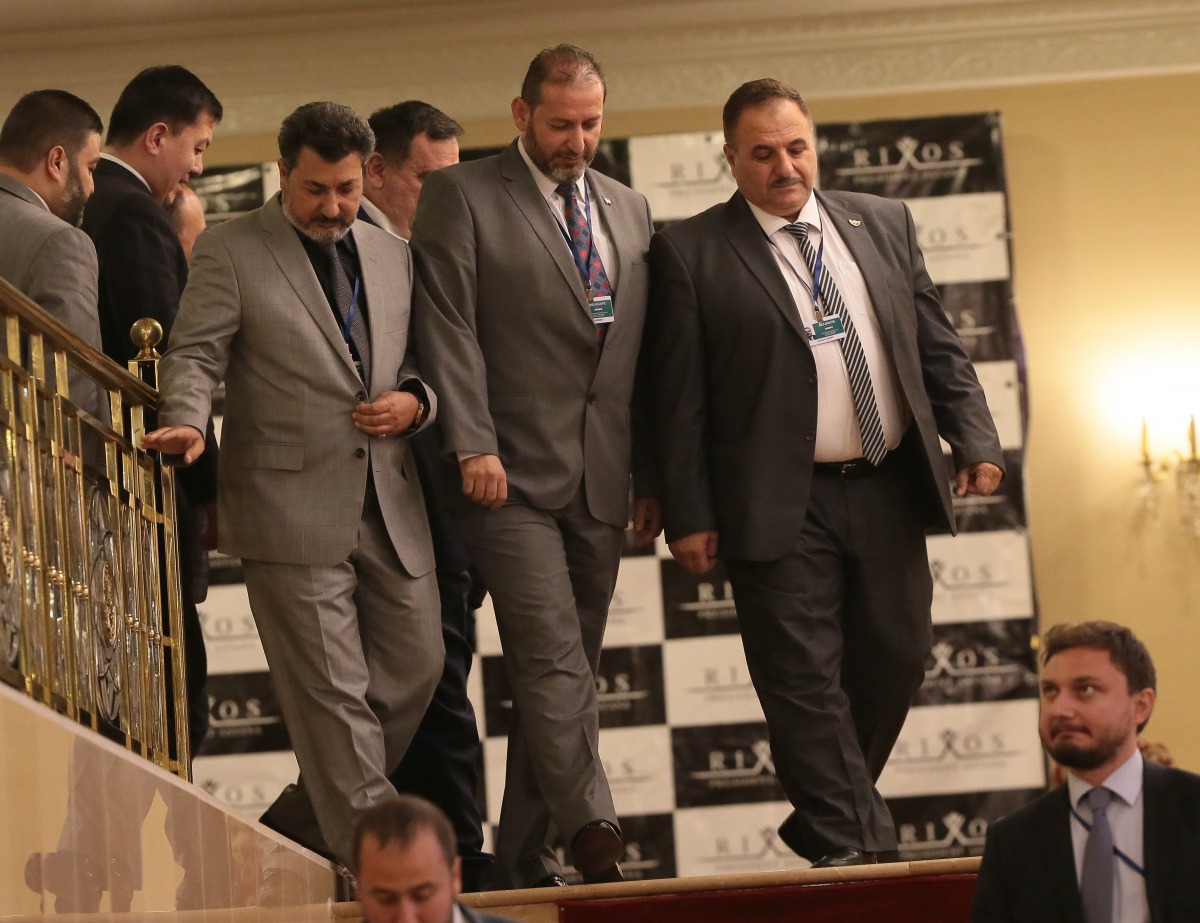 Syrian rebel representative General Ahmad Berri (R) and other attendees walk during a seventh round of Syria peace talks in Astana on October 31, 2017.  AFP / Stanislav Filippov