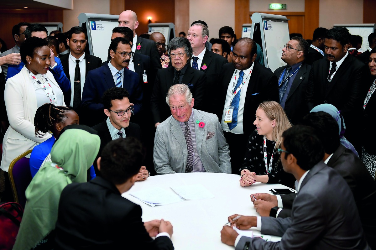 Britain's Prince Charles (C) meets participants during the Commonwealth Youth Event at the Nottingham University Campus in Semenyih, outside Kuala Lumpur on November 3, 2017. AFP / Mohd Rasfan
