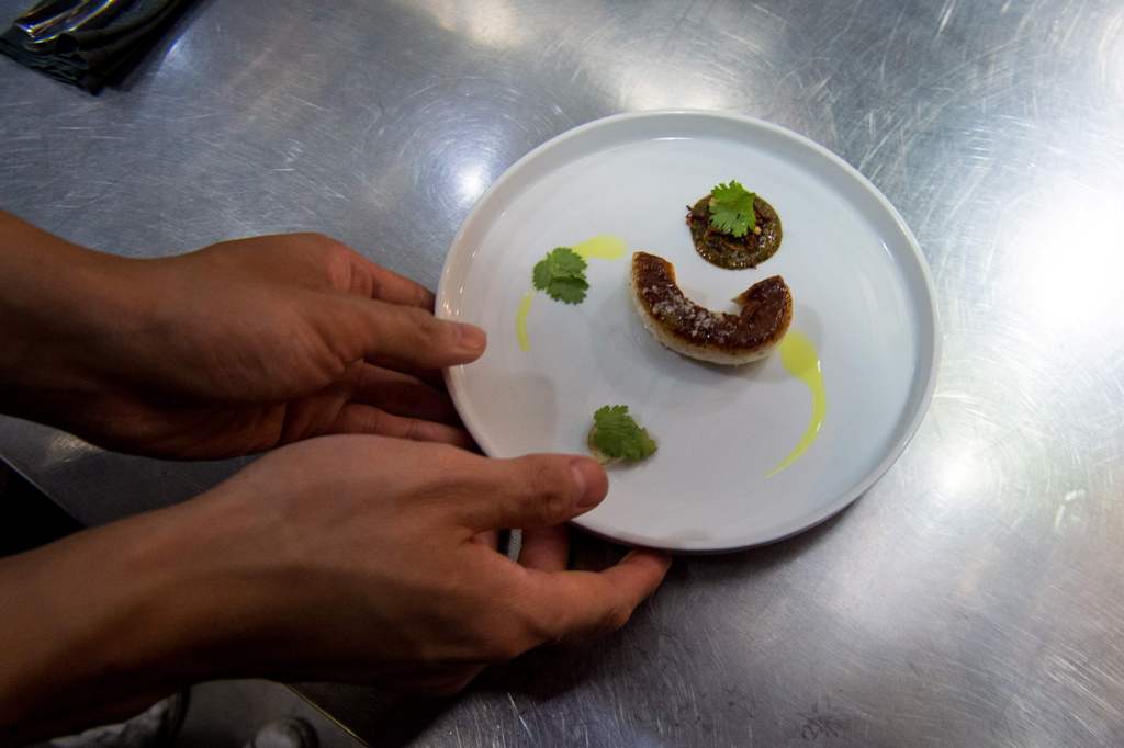 A file photo of a staff member of Ultraviolet restaurant working inside the kitchen as they prepare for their guests in Shanghai October 11, 2017. / AFP / CHANDAN KHANNA
