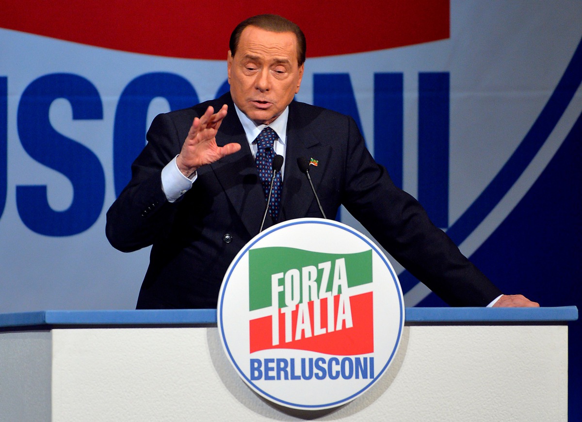 Former Italian Prime Minister and president of the Italian center-right Forza Italia (FI) party, Silvio Berlusconi during a rally on May 22, 2014. AFP / Andreas Solaro