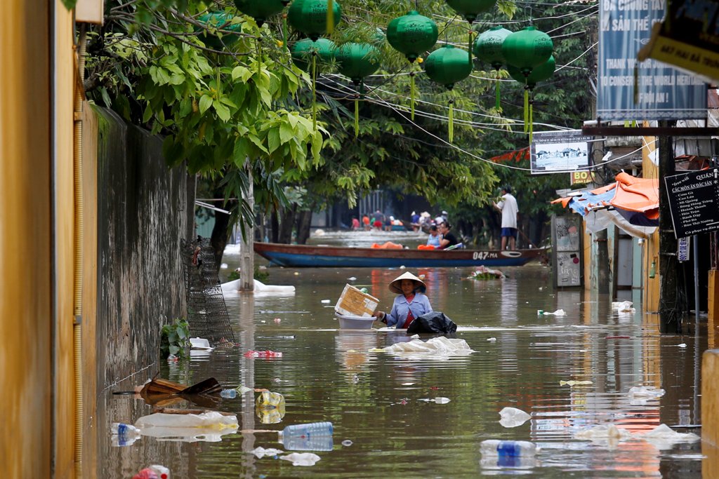 A woman wades along submerged by Typhoon Damrey houses in the UNESCO heritage ancient town of Hoi An, Vietnam November 7, 2017. REUTERS/Kham.