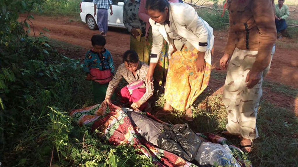 Villagers cover the body of Myanmar land rights activist Htay Aung, who was beaten to death by a mob, Nov. 1, 2017.