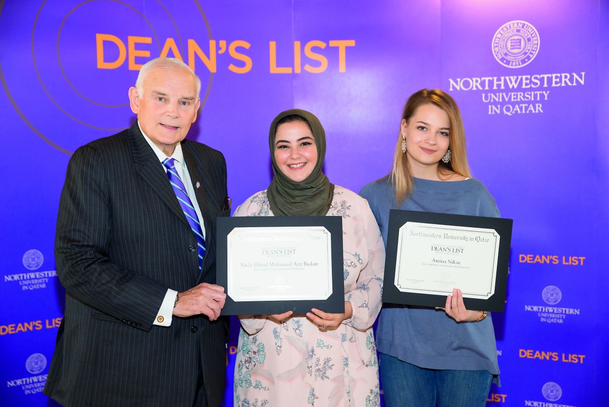 Everette E Dennis, Dean and CEO of NU-Q, with students holding certificates for excellence. 