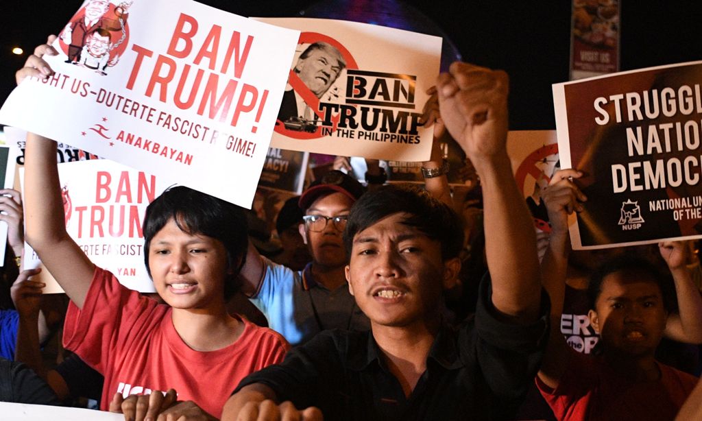 Student activists hold anti US President Donald Trump banners during a lightning rally before the start of the 31st Association of Southeast Asian Nations (ASEAN) Summit, in Manila on November 12, 2017.  / AFP / Noel CELIS
