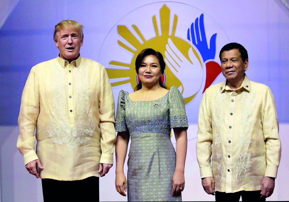 U.S. President Donald Trumpposes with Philippine President Rodrigo Duterte and his partner Cielito Avanceno before the Special Gala Celebration of the 50th Anniversary of ASEAN in Manila, Philippines November 12, 2017. Reuters/Aaron Favila