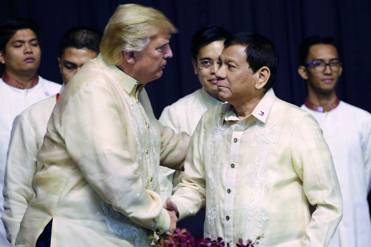 U.S. President Donald Trump shakes hands with Philippines President Rodrigo Duterte during the gala dinner marking ASEAN's 50th anniversary in Manila, Philippines, November 12, 2017. Reuters/Athit Perawongmetha
