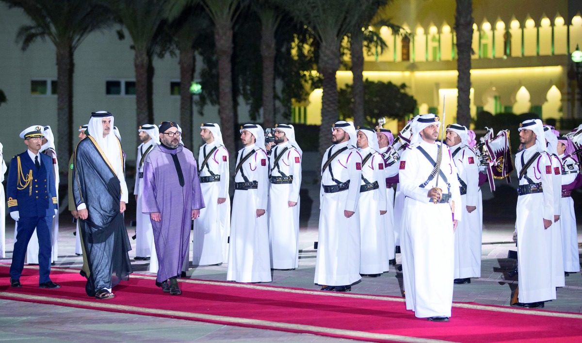 Emir H H Sheikh Tamim bin Hamad Al Thani and H M King Mohammed VI of Morocco reviewing the guard of honour at the Emiri Diwan yesterday.