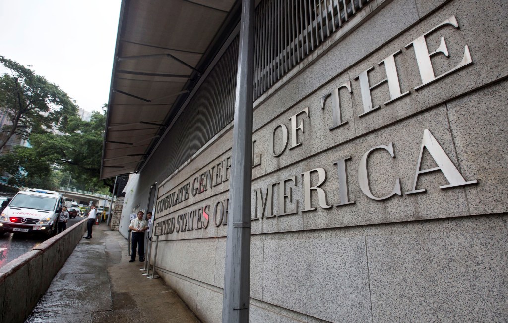 A police van stands parked on the road in front of the US consulate in Hong Kong after a suspicious envelope sparked a security alert on the premises on November 13, 2017. — AFP pic.