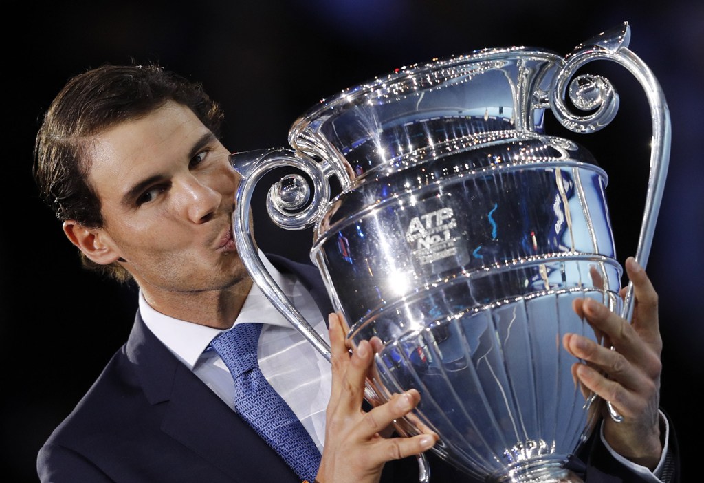 Spain's Rafael Nadal kisses the ATP World Tour No 1 Trophy at the presentation ceremony during Day One of the ATP World Tour Finals tennis tournament at the O2 Arena in London on November 12, 2017. / AFP / ADRIAN DENNIS