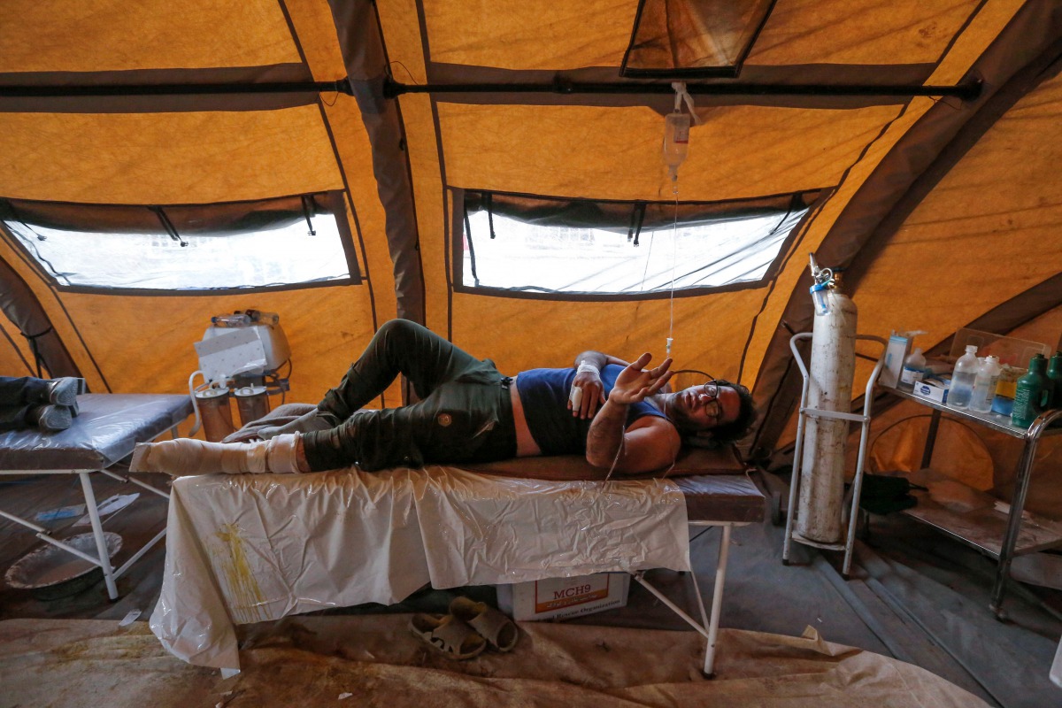 An Iranian quake victim lies on an operating bed after receiving treatment at a field hospital in the town of Sarpol-e Zahab in the western Kermanshah province near the border with Iraq, on November 14, 2017, following a 7.3-magnitude earthquake that left