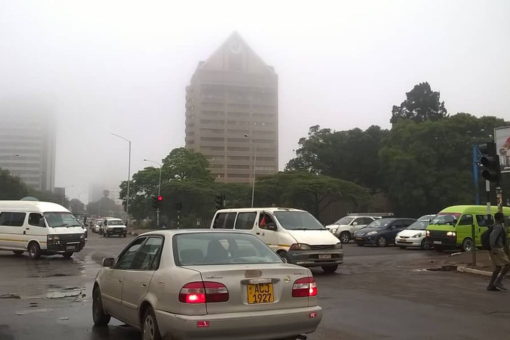 Cars drive on a street in the Zimbabwean capital Harare on November 15, 2017. AFP / Jekesai Njikizana 