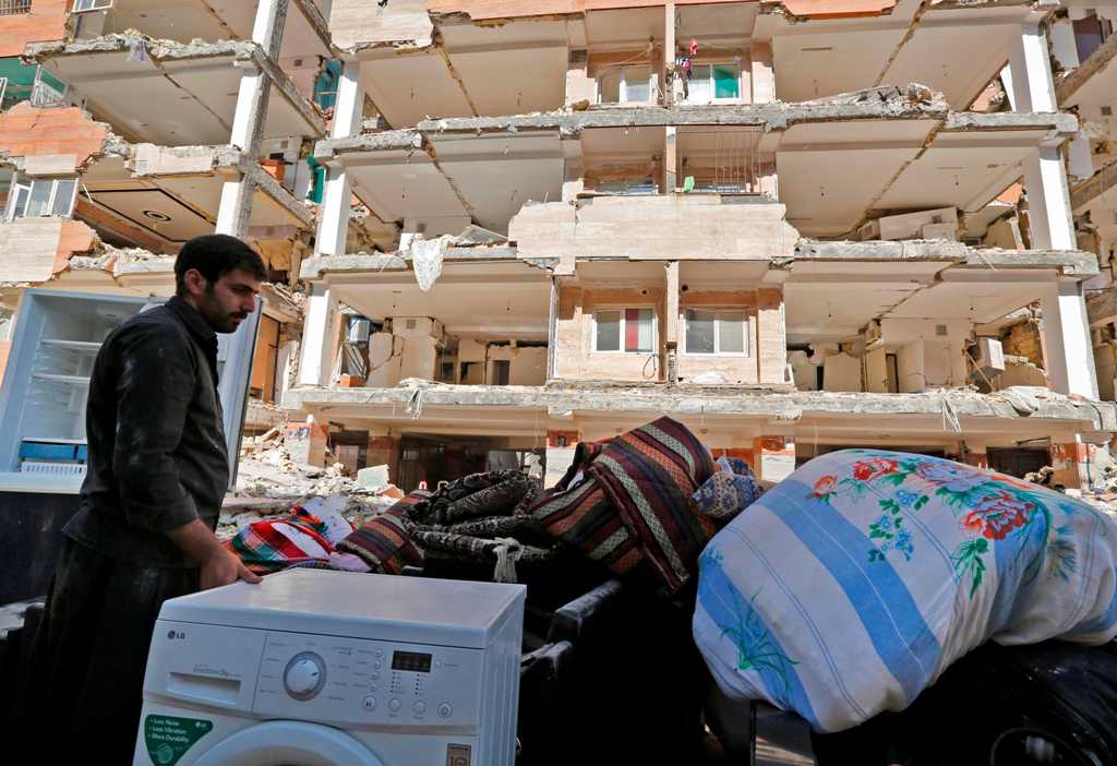 Iranians salvage their furniture and household appliances as they bring them outside the damaged buildings in the town of Sarpol-e Zahab in the western Kermanshah province near the border with Iraq, on November 15, 2017, following a 7.3-magnitude earthqua