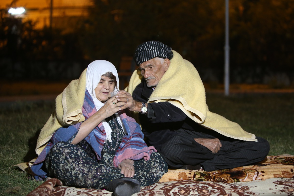People sit outside as a precaution during night at Darbandikhan district of Suleymaniyah after an earthquake measuring 7.3 on the Richter scale rocked northern Iraq and Iran on 13th of November 2017, in Suleymaniyah, Iraq on November 15, 2017. (Feriq Fere