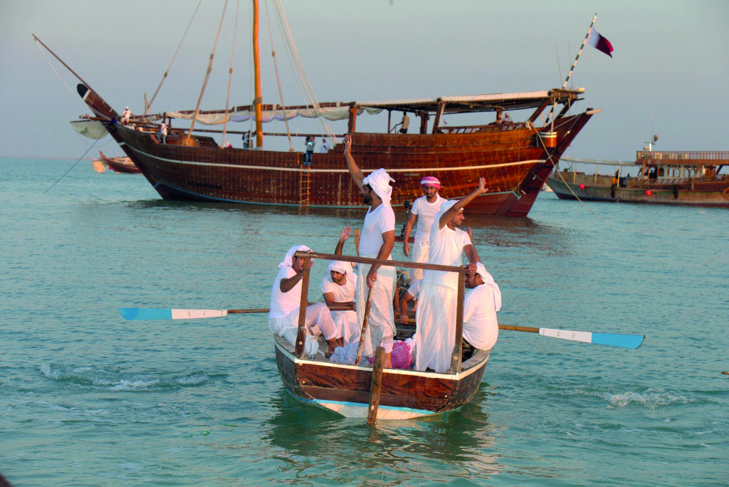 Qatari sailors wave goodbye as they head towards Fath Al Kheir which will take them on a month-long journey to Oman and Kuwait and back.

