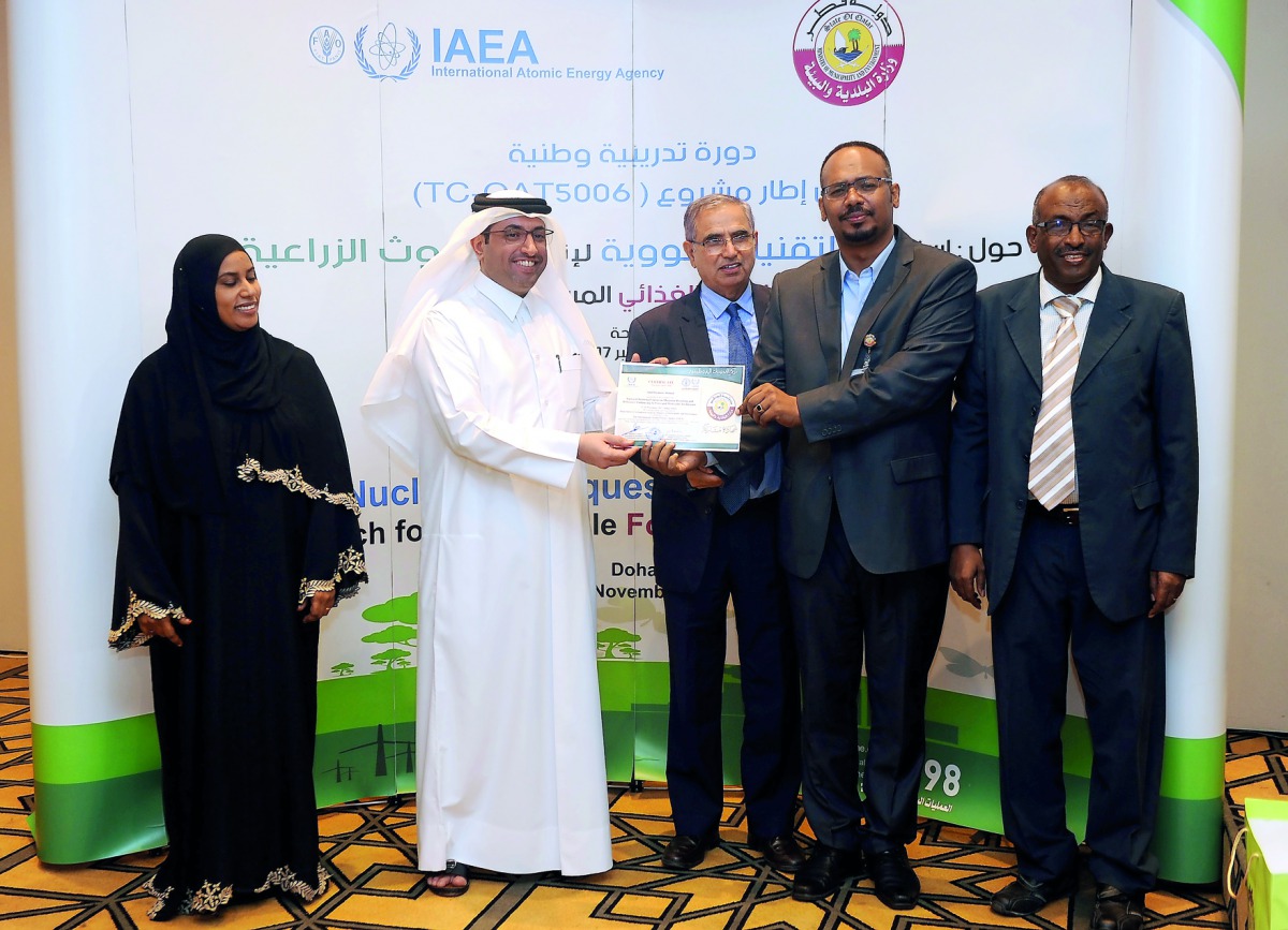 Hamad Saket Al Shamari (second left), Assistant Director of the Agricultural Research Department at the Ministry of Municipality and Environment, and Dr Rajbir Sangwan (third left), Director of UNIDO, giving a certificate to trainees on closing session of