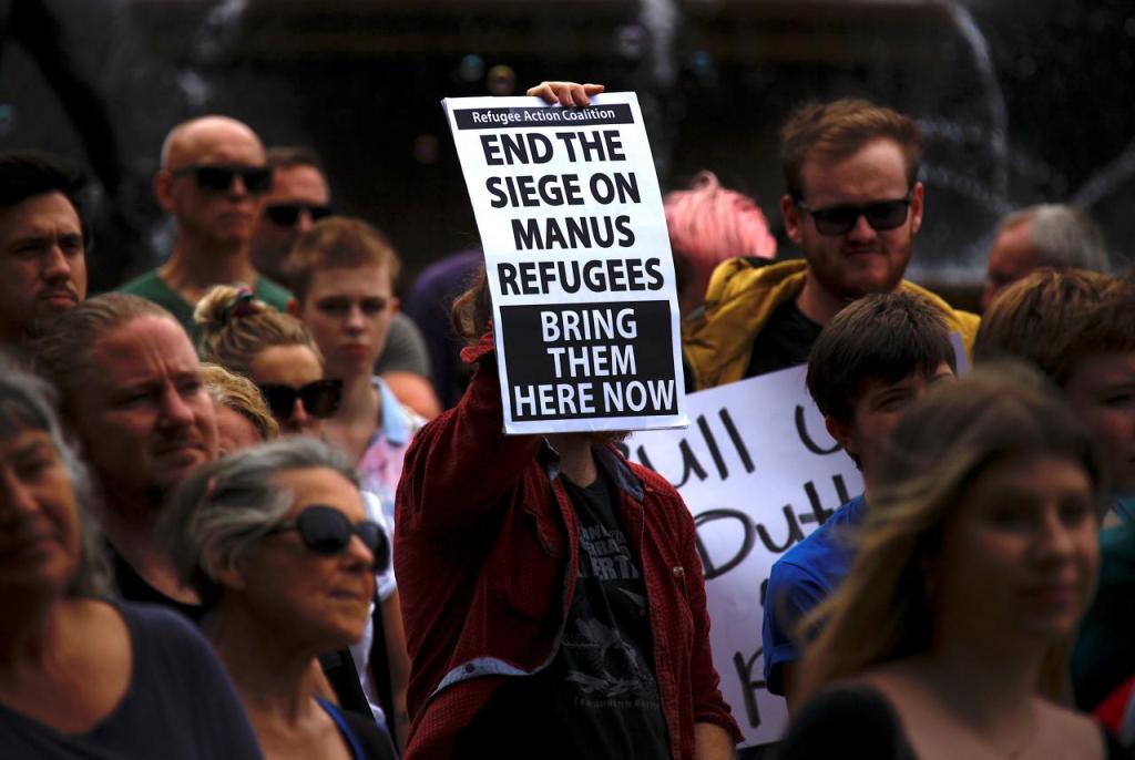 Refugee advocates hold placards as they participate in a protest in Sydney, Australia, against the treatment of asylum-seekers at Australia-run detention centres located at Nauru and Manus Island, November 18, 2017. REUTERS/David Gray